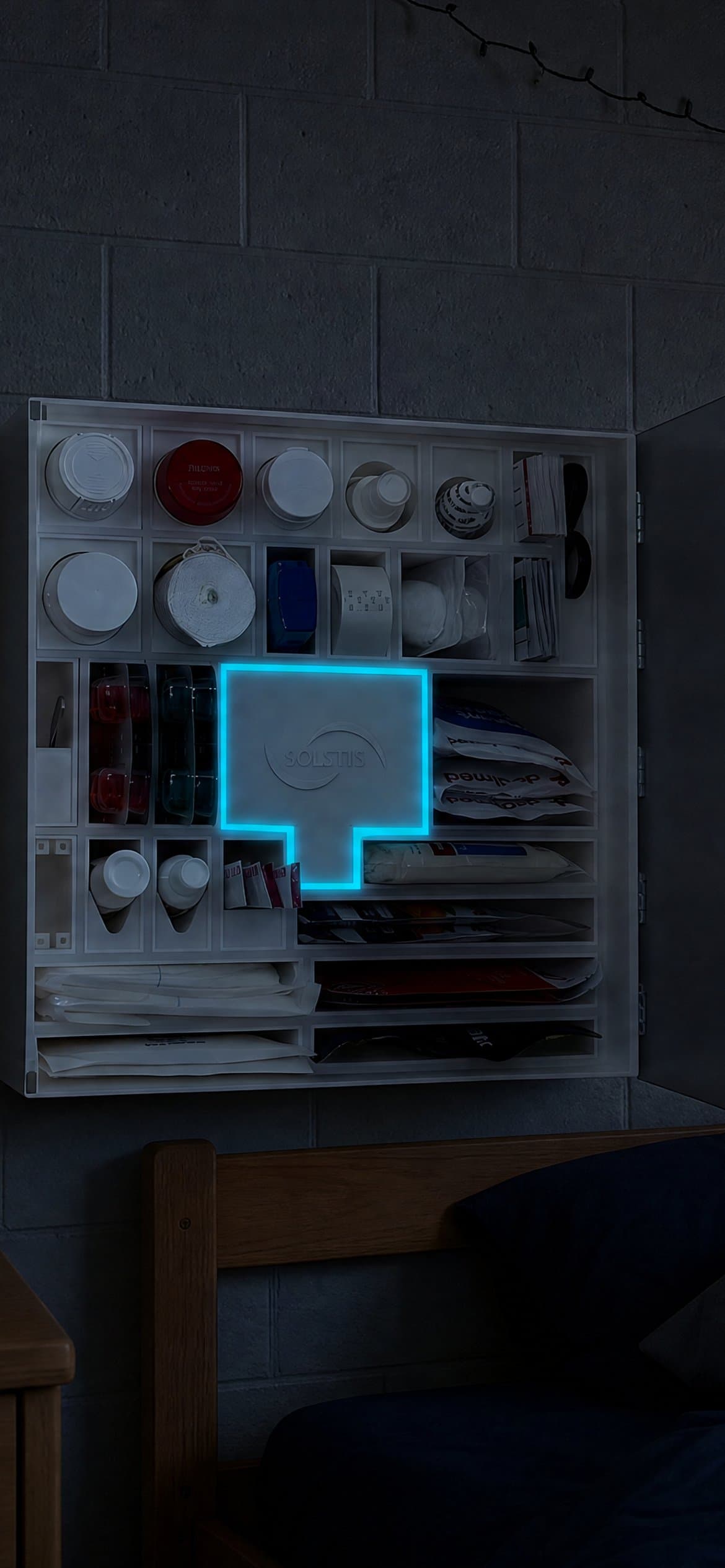 A dark dorm room at night. The Solstis cabinet hangs open on the wall, its cyan glow on.